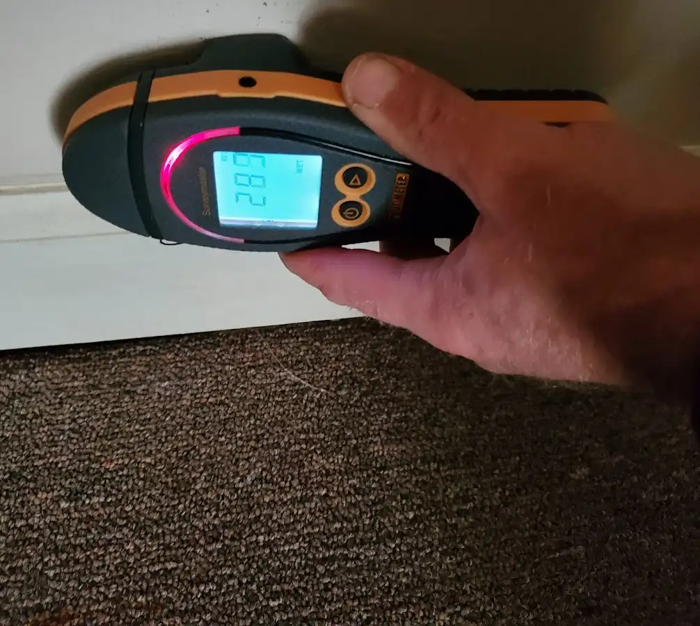 Moisture detection at baseboard during Storm Damage Restoration in Roma